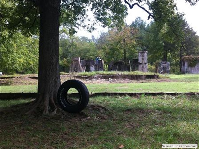 Tire swing with Power House ruins<br/>in the background